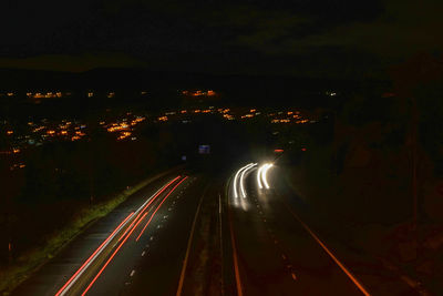 High angle view of light trails on road at night