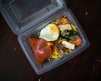 Mee bandung muar in a take out box, a malaysia delicacy noodle originated from muar, malaysia.