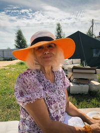 Portrait of woman wearing hat against plants