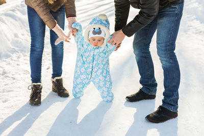 Low section of father and son standing outdoors