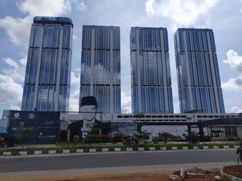 Low angle view of buildings against cloudy sky