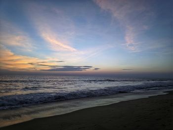 Scenic view of beach against sky during sunset