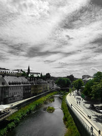 High angle view of river amidst city against sky