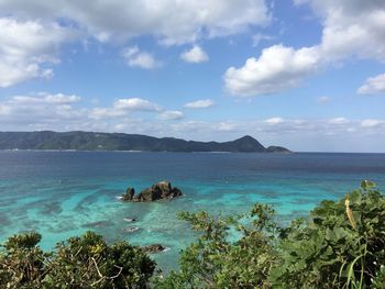 Scenic view of sea against cloudy sky