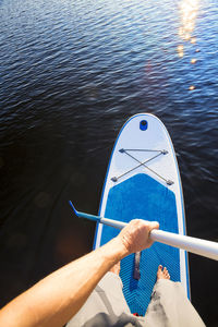 Low section of man with ball in water