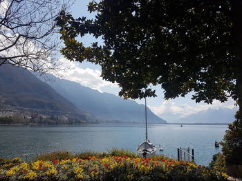 Scenic view of lake by mountain against sky