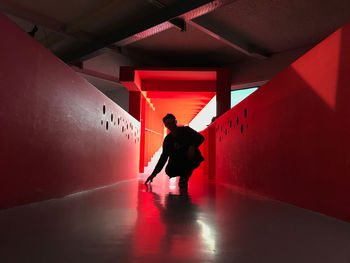 Full length of man walking in illuminated building