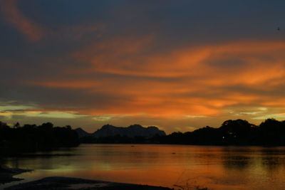 Scenic view of lake against orange sky