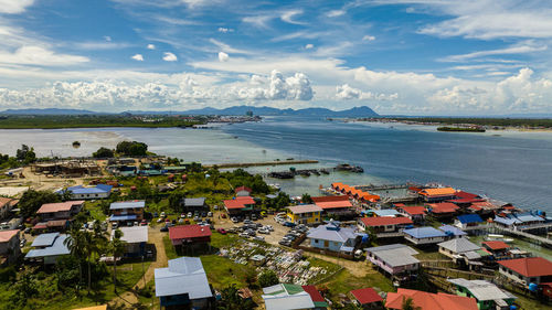 High angle view of townscape by sea against sky