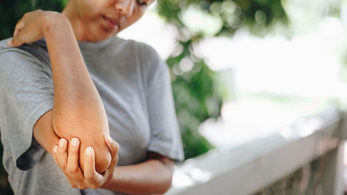 Midsection of couple sitting outdoors