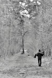 Full length of woman standing on tree