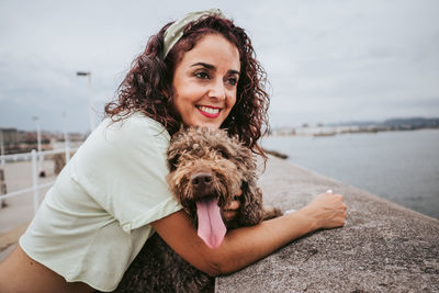 Portrait of smiling young woman with dog