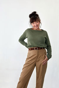 Portrait of smiling young woman over white background