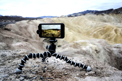 Close-up of snake on mountain against sky