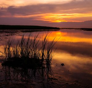 Scenic view of lake against romantic sky at sunset