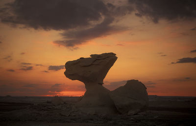 Scenic view of beach against sky during sunset