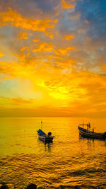 Boat in sea against sky during sunset