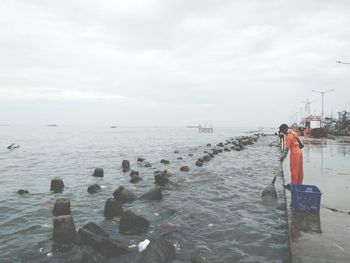 Rear view of man standing on beach