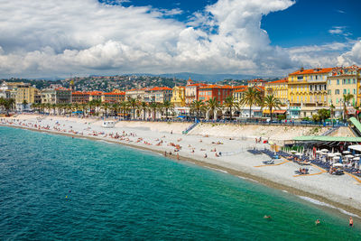 High angle view of city by sea against sky