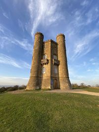 Old ruin building in field against cloudy sky broadway tower