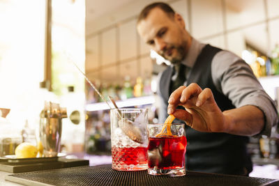 Bartender preparing cocktail at bar