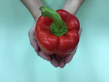 Close-up of hand holding red bell peppers