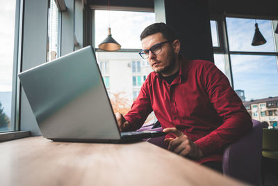 Man working on table with laptop