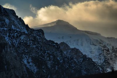 Scenic view of mountains against cloudy sky