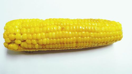 Close-up of yellow slices over white background