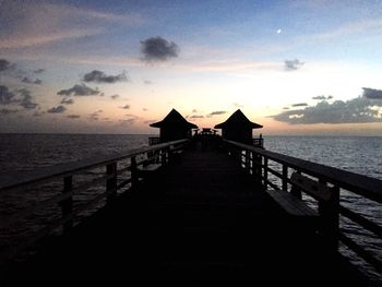 Pier on sea at sunset