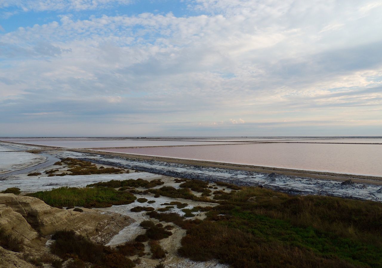 water, tranquil scene, tranquility, scenics, sea, horizon over water, beach, beauty in nature, sky, shore, nature, cloud - sky, calm, non-urban scene, coastline, cloud, ocean, seascape, outdoors, day, remote, majestic, solitude, cloudy, no people, tourism, vacations, coastal feature