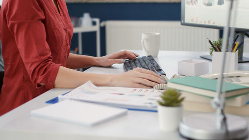 Midsection of business colleagues working on table