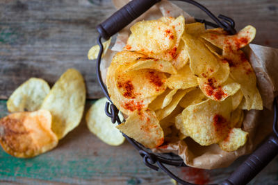 High angle view of fresh crunchy potato chips on table