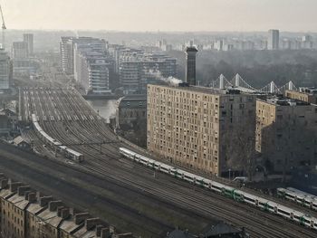 High angle view of railroad tracks amidst buildings in city