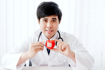 Portrait of doctor with stethoscope sitting in hospital