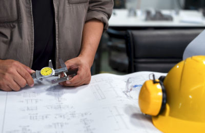 Midsection of man working on paper