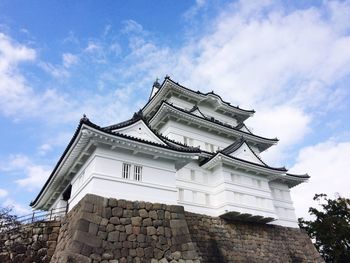 Low angle view of building against cloudy sky