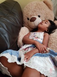 Close-up of girl lying on sofa at home
