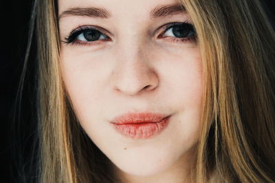 Close-up portrait of beautiful woman puckering lips