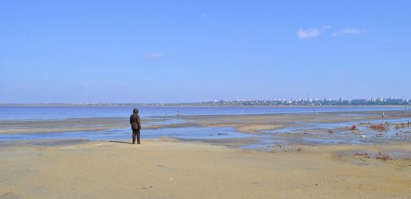 Man standing on beach against sky