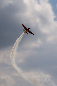 Low angle view of airplane flying against sky