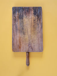 Directly above shot of wooden table against yellow wall