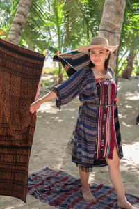 Rear view of woman standing against wall