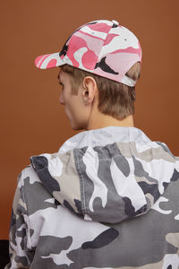 Portrait of boy standing against wall