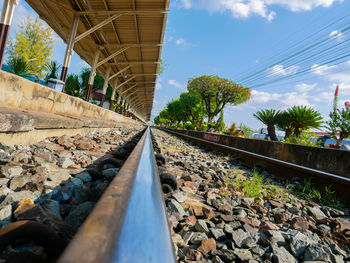 Surface level of railroad tracks against sky