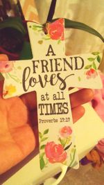 Close-up of hand holding paper with text