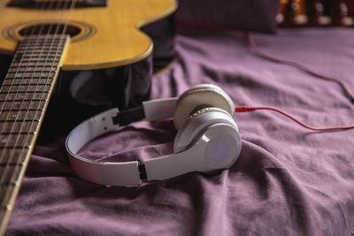 Close-up of guitar on bed