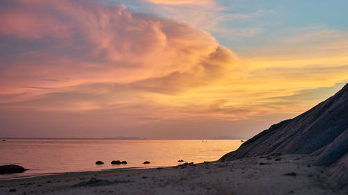 Scenic view of sea against orange sky