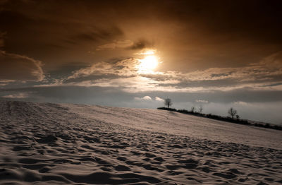 Scenic view of beach against sky during sunset