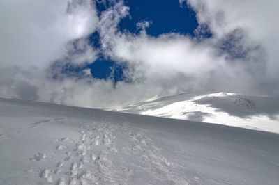 Scenic view of snow covered mountains against sky